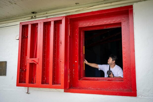 Ishii Hiroshi shows a blast window still in place at Xavier High School, on the main island of Weno. (© Julian Ryall)