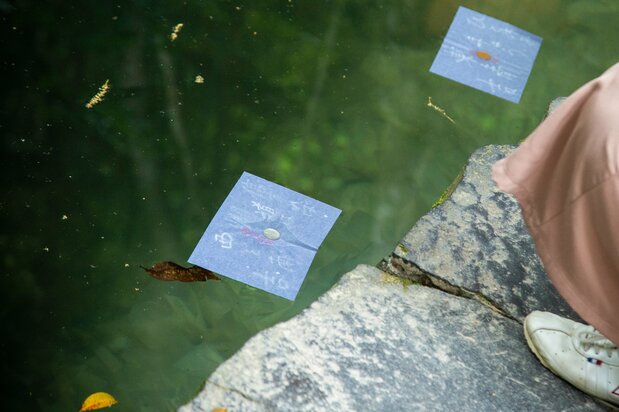 Visitors place either a ¥10 or ¥100 coin on their fortune-telling paper.