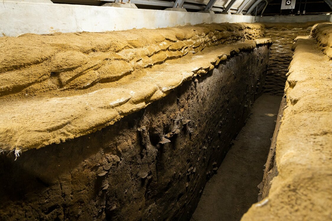 An exhibit showing artifacts in different layers of soil.