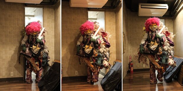 Tiger squeezes through a narrow door backstage at Theatre Shinjuku. His bulky costume weighs more than 10 kilograms.