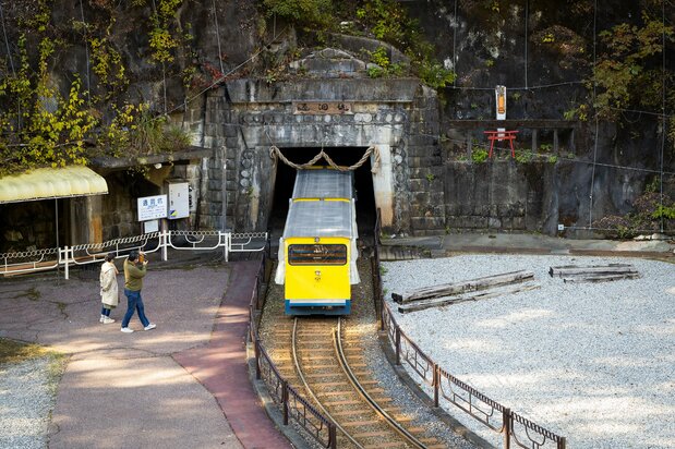A trolley train enters the Tsūdō mine shaft, where mining operations began in 1885.