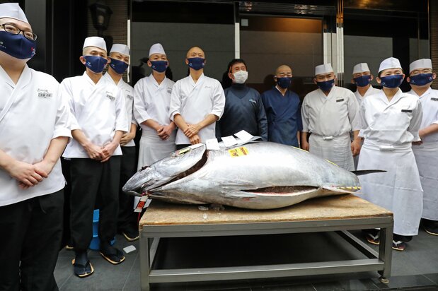 今年の一番マグロが納品された、すし店「銀座おのでら」の前で。中央右の紺色の上着が「やま幸」の山口幸隆社長 写真:時事