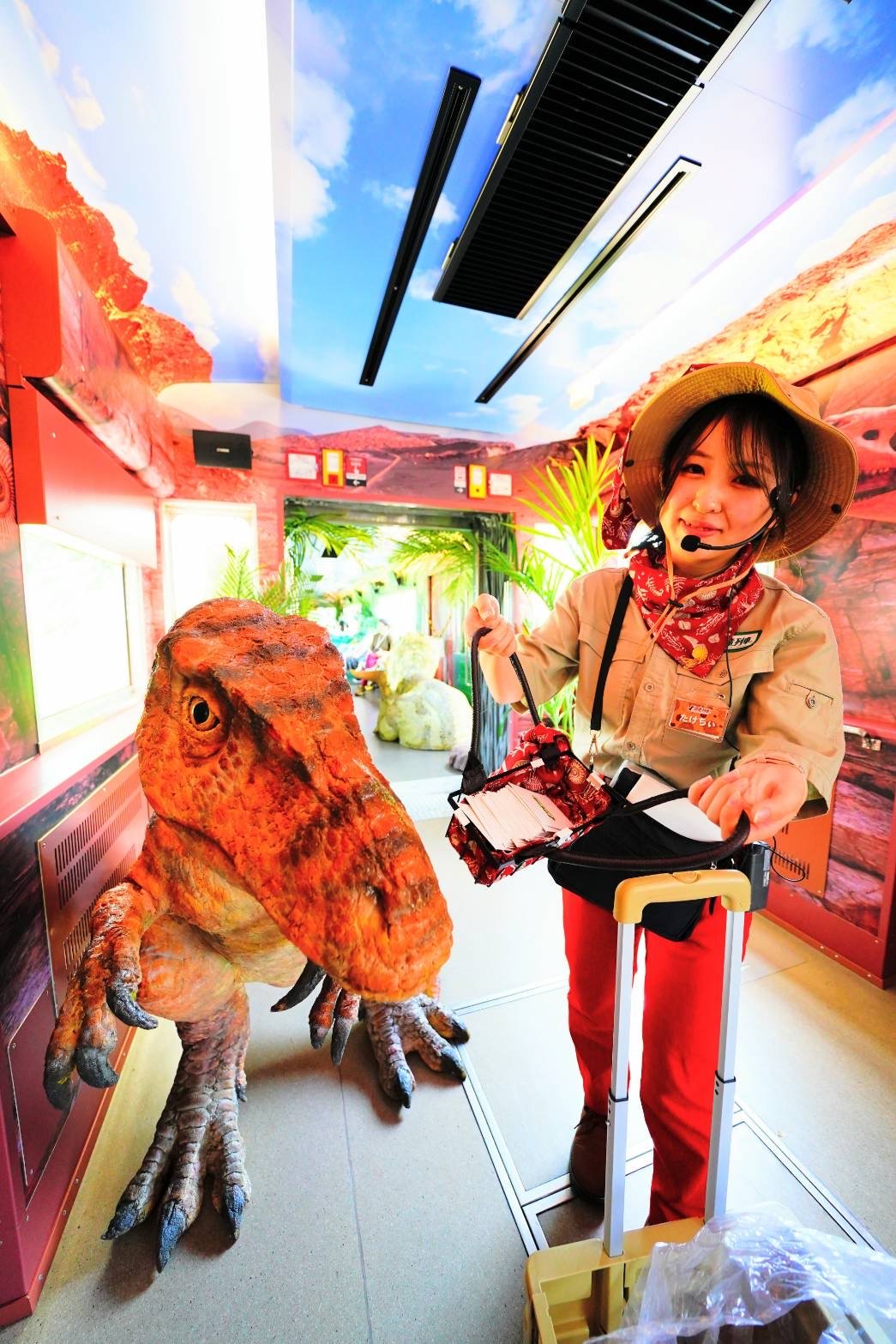 An attendant on the Dinosaur Train entertains passengers. (© Echizen Railway)