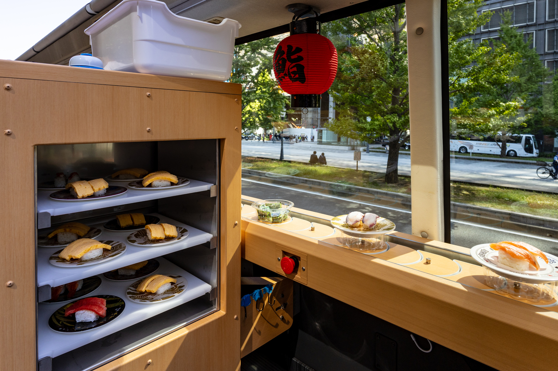 Freshly prepared sushi is taken to the upper deck on a food-delivery lift. (© Nippon.com)