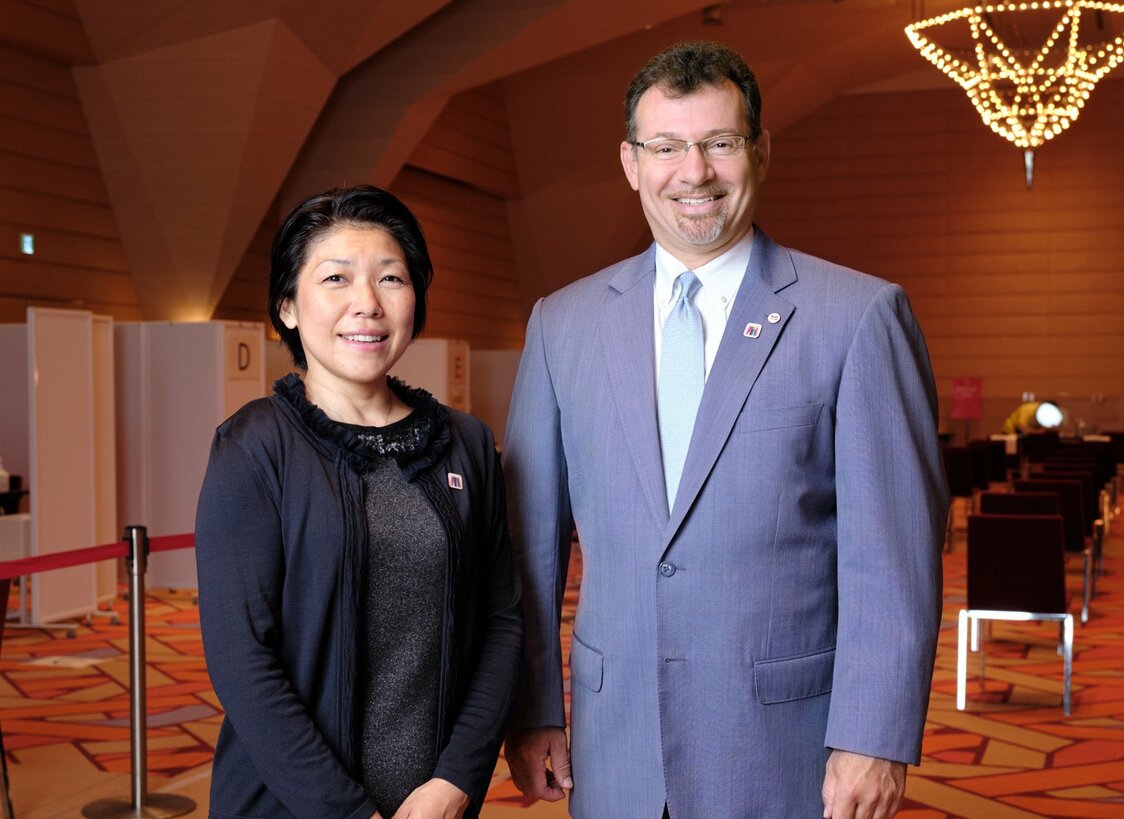 Sam Rogan (right) and vaccination center staff member Dr. Naoko Fleming