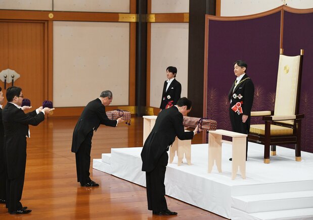 L'épée Kusanagi et le joyau Magatama ont été présentés enfermés dans des boîtes lors de la cérémonie d'intronisation de l'empereur Naruhito (à droite) le 1er mai 2019. (© Jiji; pool photo)