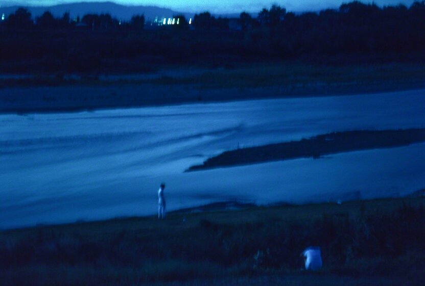 In Japanese Buddhism, the souls of the dead cross the Sanzu-no-Kawa to get to the afterlife. The eerie glow of this photograph was achieved by using a long exposure at dusk, at the Yahagi River in Aichi Prefecture. (© Ōnishi Naruaki)