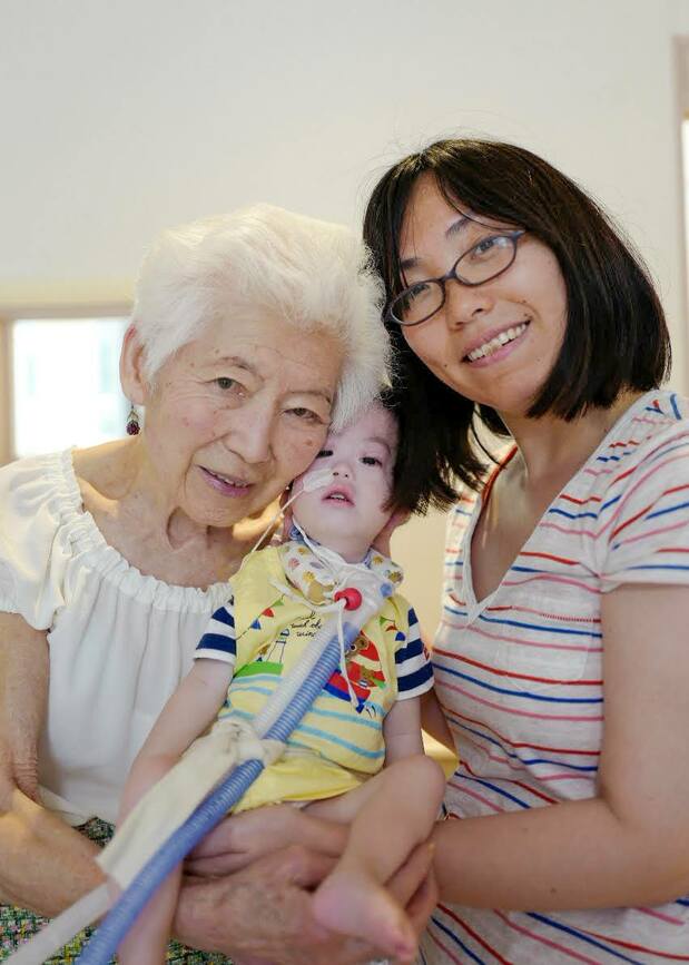 Kidani, at left, with a mother and child staying at Momiji House. (Photo courtesy of KidsFam Foundation)