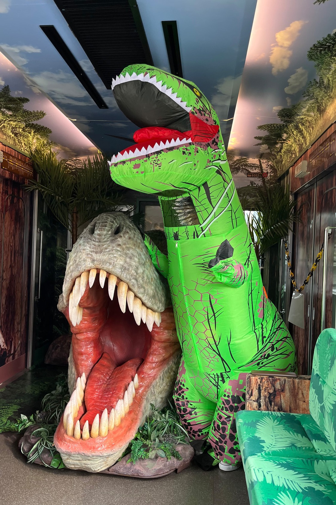 Katō Fusami in her T-rex suit poses with at a display on the Dinosaur Train. (© Katō Fusami)