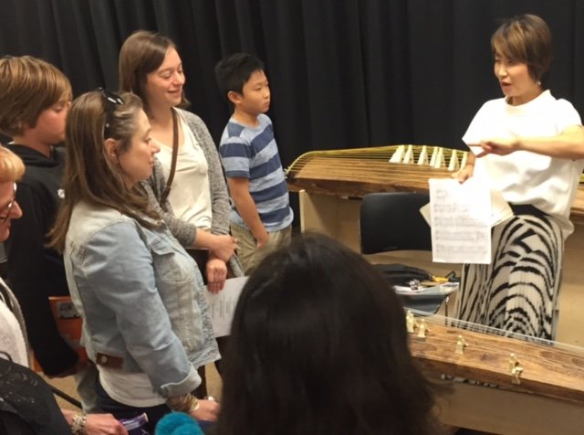 After a concert at a private library in 2016, Ishigure demonstrates two different styles of musical notation: traditional koto notation and the familiar Western musical staff also used for koto music. (Courtesy Ishigure Masayo)