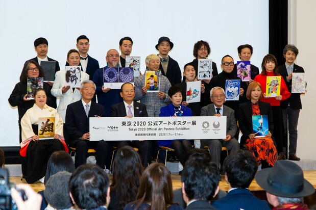 Artists hold 14 of the posters at the opening ceremony.