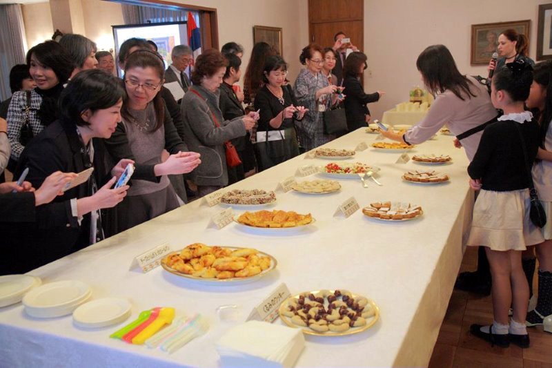 Cookies baked by staff members at the Serbian embassy delight the guests at a tea party held there.