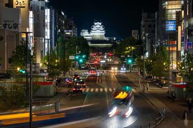 Lights illuminate Himeji Castle at night.