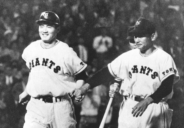 天覧試合の阪神戦でサヨナラ本塁打を放ち、川上哲治コーチ(右)に迎えられる巨人の長嶋茂雄選手(1959年6月25日、共同)
