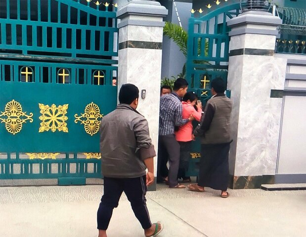 Moon Moon Pan being forced into the company compound. Ah Je took this photo with his cellphone and posted it on Facebook. (Courtesy Myitkyina News Journal)