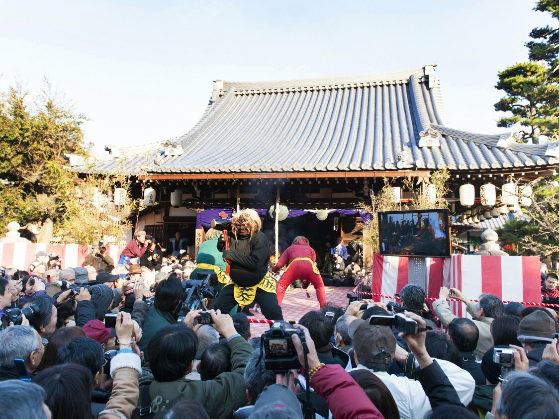 鬼法楽が行われる舞台の周りは、カメラを持った多くの見物人でにぎわう