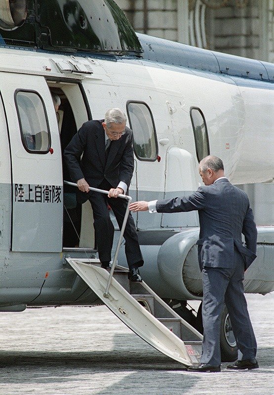 Emperor Shōwa steps from a helicopter that conveyed him from his retreat in Tochigi Prefecture to Tokyo on August 13, 1988. (© Jiji)
