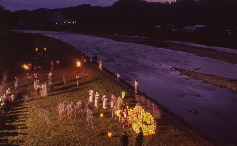 People release lanterns onto the Hinokinai River as part of the midsummer Obon festival in Kakunodate, Akita Prefecture. The lanterns light the souls of the ancestors on their journey downriver and back across the sea, to the land of the dead. (© Ōnishi Naruaki)