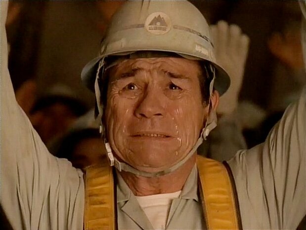 Alien Jones gets emotional as he joins fellow workers in a round of “banzai” cheers to celebrate the successful dynamiting of a new tunnel.