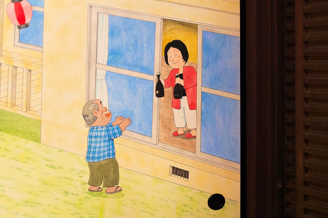 Kitami’s late wife appears at a door, drawn in a higher place than any other character.