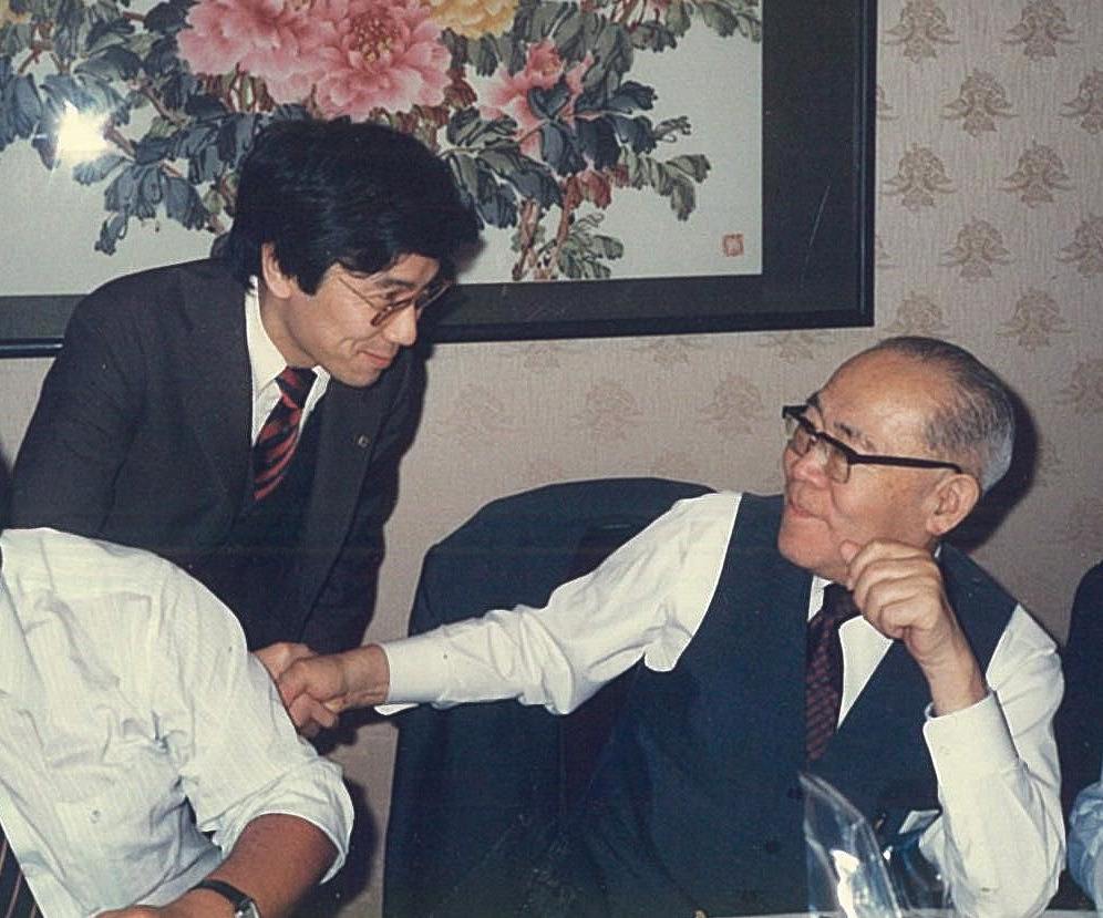 74歳の誕生日を迎えた伊東正義氏と握手する筆者（1987年12月15日、東京・赤坂の山王飯店）＝伊東事務所提供