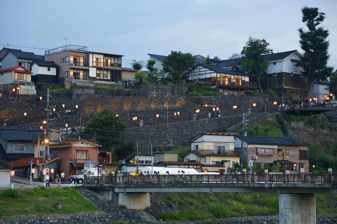 Lanterns light up a slope at dusk. (© Haga Library)