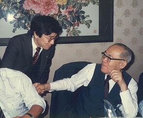 74歳の誕生日を迎えた伊東正義氏と握手する筆者(1987年12月15日、東京・赤坂の山王飯店)=伊東事務所提供
