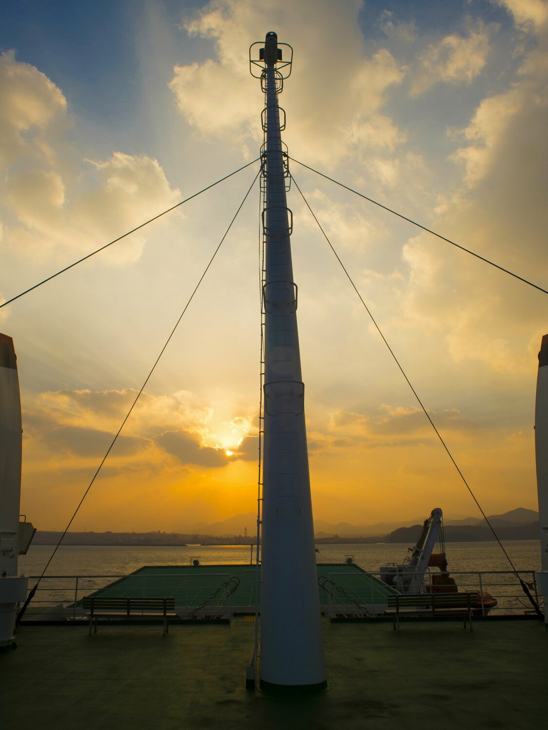 Sunset viewed from the deck of the Narushio, with islands slipping by as the ship goes on its way.