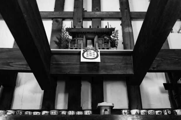 A household shrine overlooks the dining area.