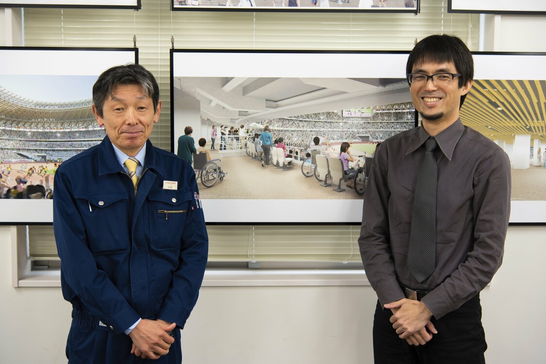 車いす席の完成イメージパースを挟んで、左が小松さん、右が田阪さん