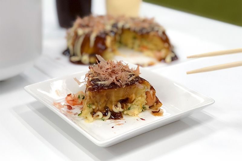 Rice cooker okonomiyaki smothered in special sauce, mayonnaise, and bonito flakes.