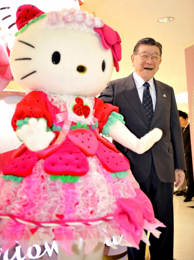 Sanrio CEO Tsuji Shintarō poses with Hello Kitty in October 2009. (© Jiji)