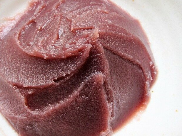 Pressing bean paste through a fine sieve produces smooth koshian.