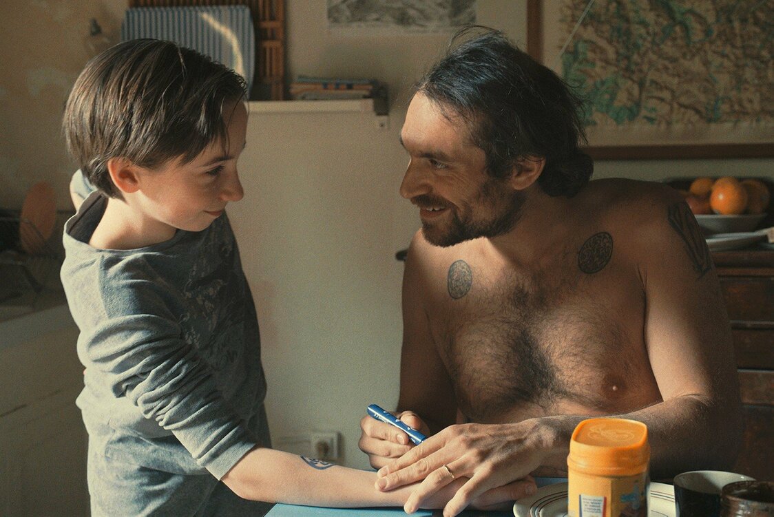 クラリスの夫マルクをアリエ・ワルトアルテ（右）が演じる　© 2021 - LES FILMS DU POISSON – GAUMONT – ARTE FRANCE CINEMA – LUPA FILM