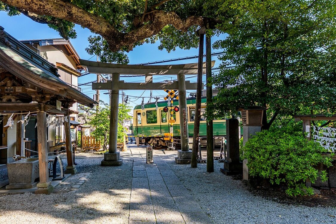 Un tren de la Enoden pasa tras el torii del santuario Goryō. (© Benjamin Parks)