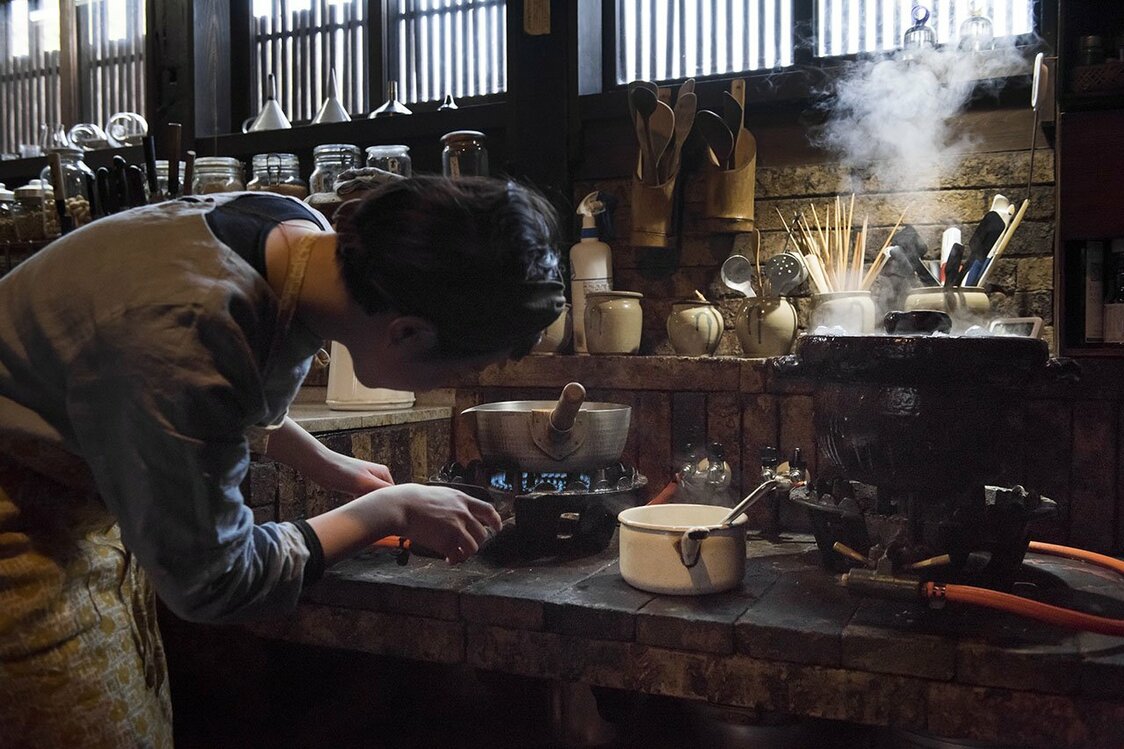With experience, she learns how to adjust the flame and add water as needed.