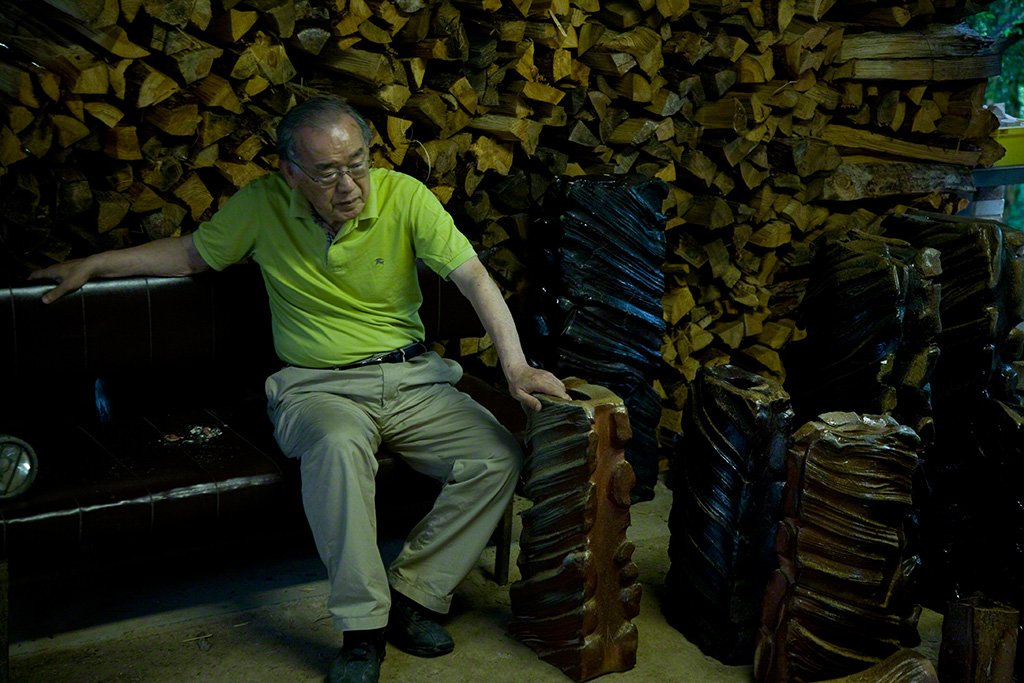 Isezaki looks on as the items are removed from the kiln.