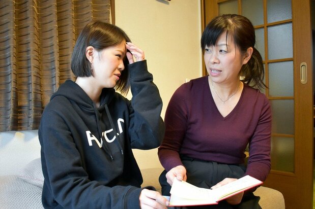 Maki and Rina’s younger sister Sae recall treasured memories, Tomorrow Book in hand.