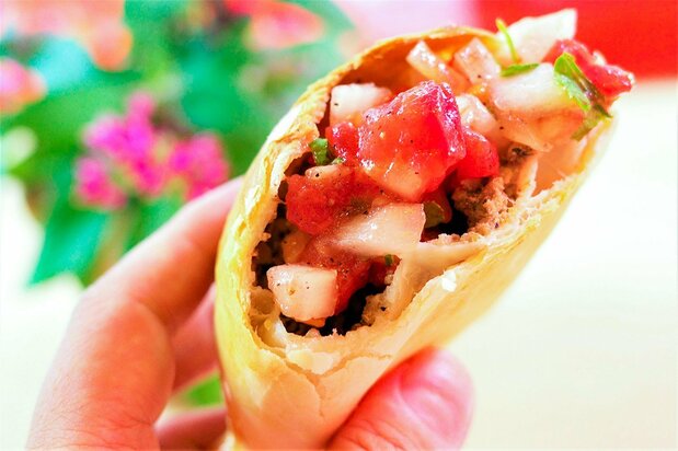 An empanada, one of the restaurant’s most popular items. The superb combination of the sour flavor of the Chilean condiment pebre and the juicy meats guarantee that they disappear quickly. (© Kumazaki Takashi)