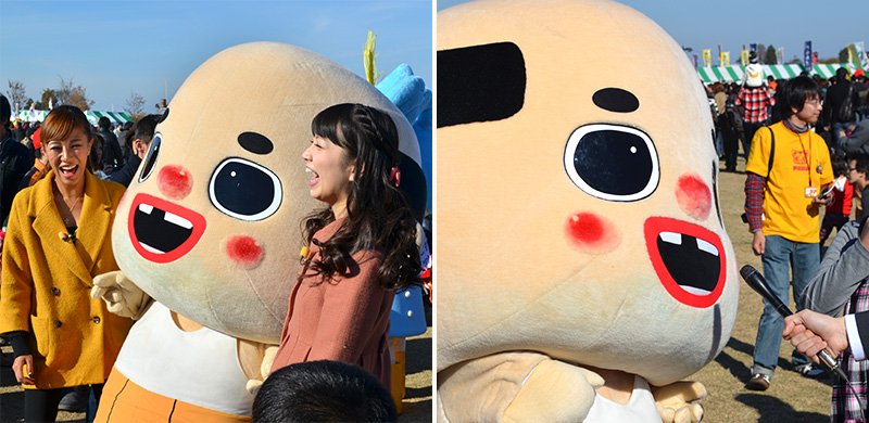 美女に囲まれ、マイクを向けられるちっちゃいおっさん