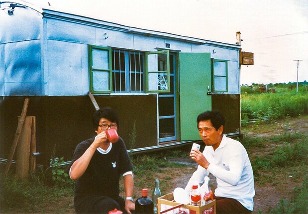 トレーラーハウスで生活をする中山氏(写真左)(1982年8月、三江平原、提供:中山氏)