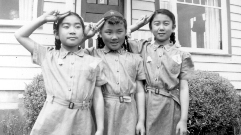 Incarcerated in Manzanar as young children, Natalie Hayashida, Jane Kitamoto, and Susan Hayashida (left to right) proudly sport Brownie uniforms in the early 1950s. (Courtesy of Densho and the Hayashida Family Collection)