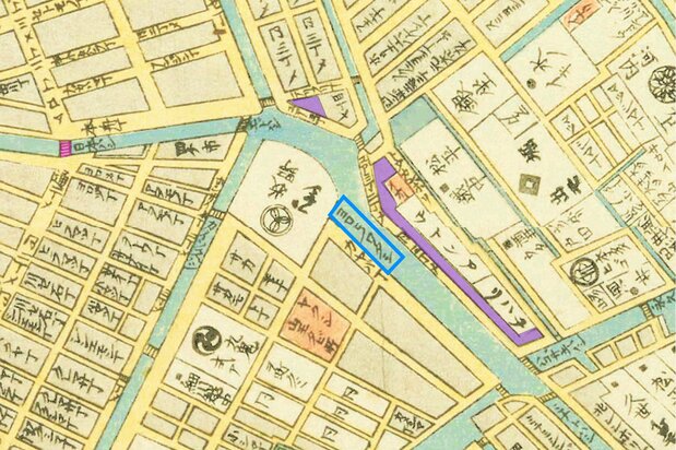 『安政改正御江戸大絵図』(1858国会図書館蔵)から、鎧の渡し(ヨロヒノワタシ)を中心に切り抜き、小網町の町域を紫、日本橋をピンクで網掛けした。付近にはたくさんの水路が張り巡らされていることから、水運の要所だったことが分かる。蔵に囲まれた「イナリ」が、現在の小網神社になった