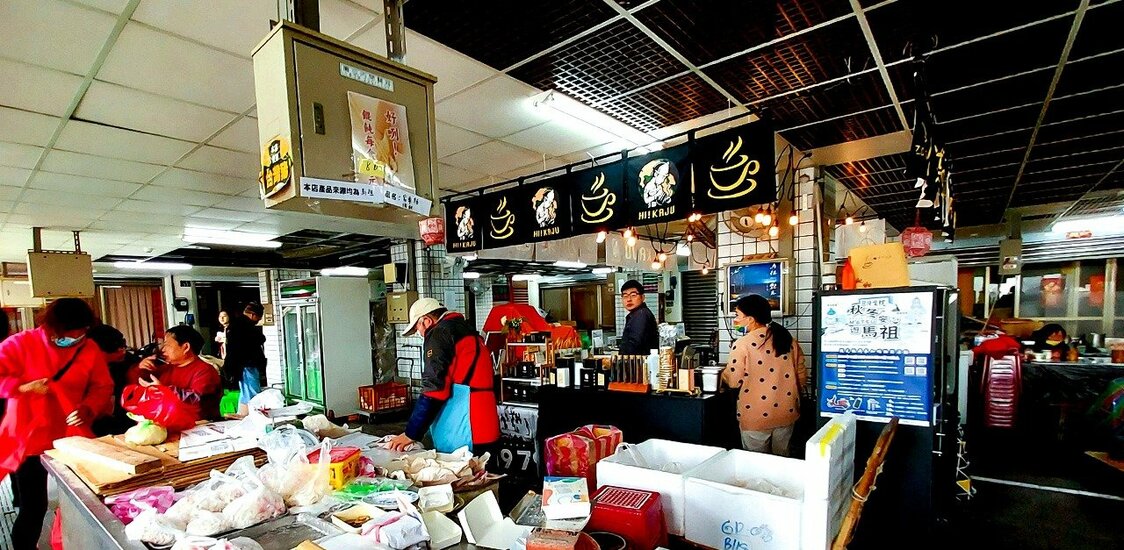 位在介壽獅子市場二樓的「小柒咖啡」，從店裡回頭看的男子正是老闆邱思奇。