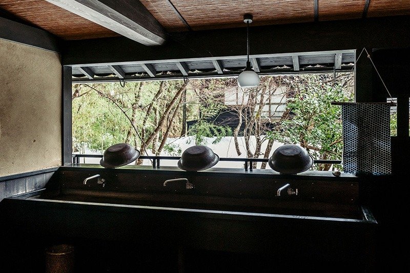 La zona donde se encuentran los lavabos da directamente al jardín interior y no está acristalada, por lo que también entra el aire.