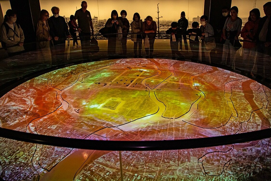 Des visiteurs regardent la vidéo d’images de synthèse par laquelle débute la visite. (© Dôune Hiroko)