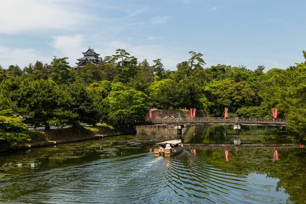 A tour boat cruises along a canal.