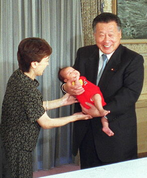 橋本氏の三女、せいかちゃん（生後1カ月）を抱く当時の森喜朗首相＝2000年6月東京・首相官邸/時事