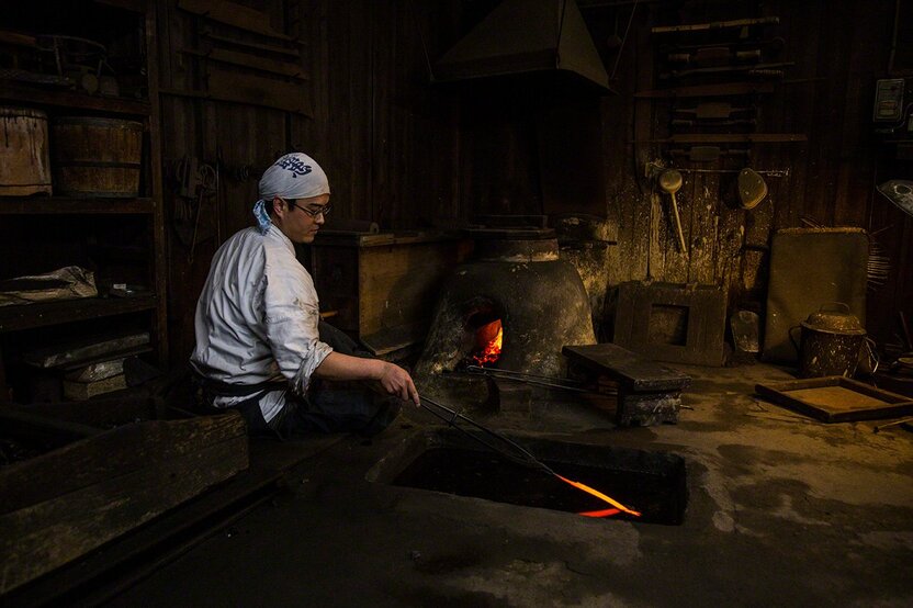 Tempering a sashimi knife at the Mizuno Tanrenjo forge in Sakai, Osaka.