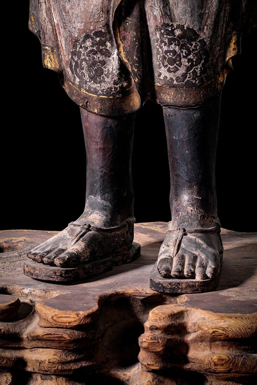 The Ashura figure wears sandals, an unusual detail for a Buddhist statue that lends it a distinctly human feel.
